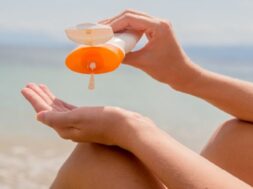 Photo of  Woman using sunscreen by the sea