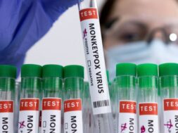 Illustration shows test tubes labelled “Monkeypox virus positive