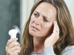 Mature Woman Experiencing Hot Flush From Menopause