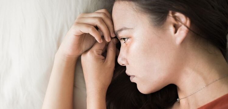 closeup-young-woman-lying-in-bed