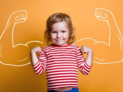 funny-strong-child-muscles-over-yellow-wall-nerd-kindergarten-kid-girl-showing-bicep-muscles-dream-confidence-success-212256163