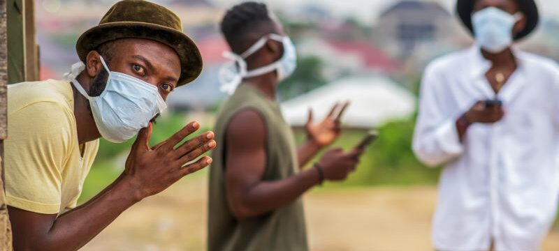 African man wearing face mask for protection,practicing social distance
