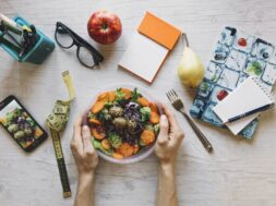 crop-hands-holding-bowl-with-salad-office