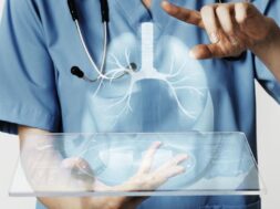 Doctors using transparent tablet with hologram medical technolog