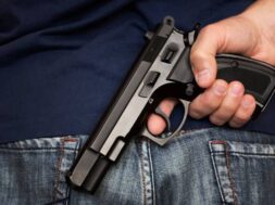 Man holding gun behind his back