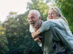 Happy senior couple smiling outdoors in nature
