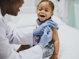 Toddler getting a vaccination by a pediatrician