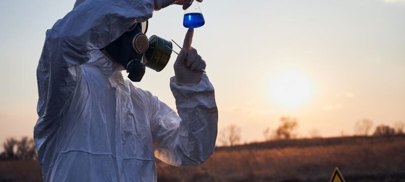 Scientist doing laboratory test in field after fire.
