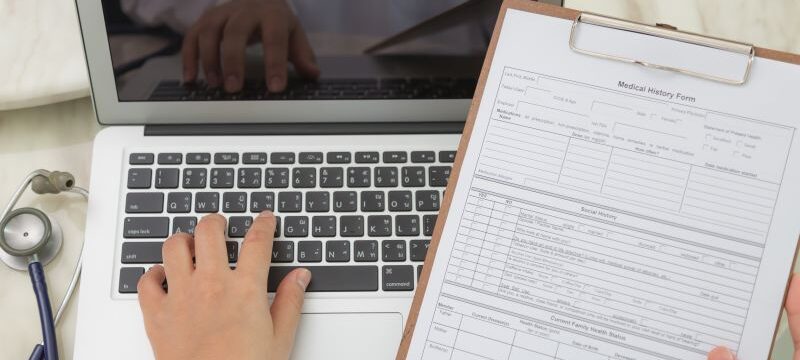 Doctor hands typing on laptop keyboard
