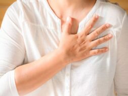 Woman is clutching her chest