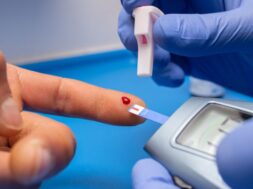 Closeup shot of a doctor with rubber gloves taking a blood test from a patient