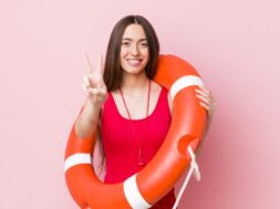 smiling and looking happy, gesturing victory or peace