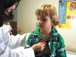 Doctor examining a child with a stethoscope at a hospital