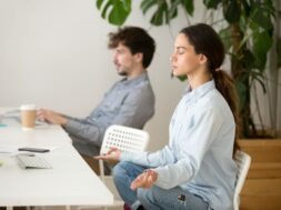 Mindful calm young woman taking break in office for meditation