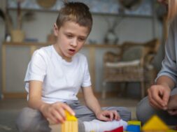 mother-playing-with-her-autistic-son-using-toys