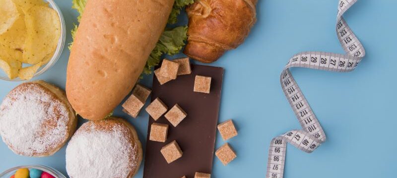 top-view-unhealthy-food-tape-measure