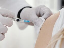 doctor-vaccinating-patient-clinic