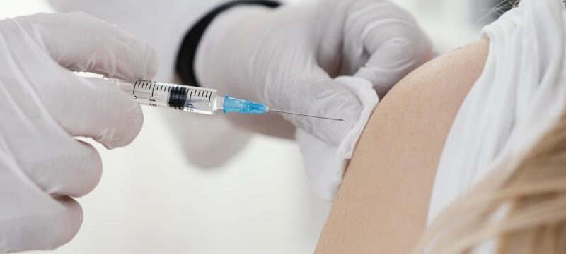 doctor-vaccinating-patient-clinic