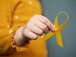 child-holding-yellow-ribbon_23-2149416299