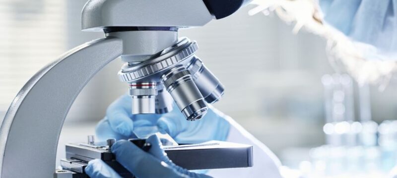 Gloved hands of young modern scientist preparing all the necessary equipment