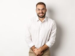 Troubled man having bladder problem, need toilet, standing over white background