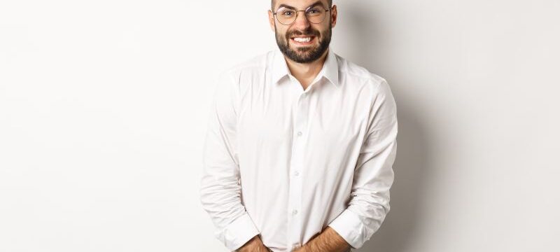 Troubled man having bladder problem, need toilet, standing over white background