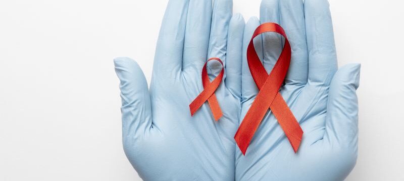 person-holding-world-aids-day-ribbon