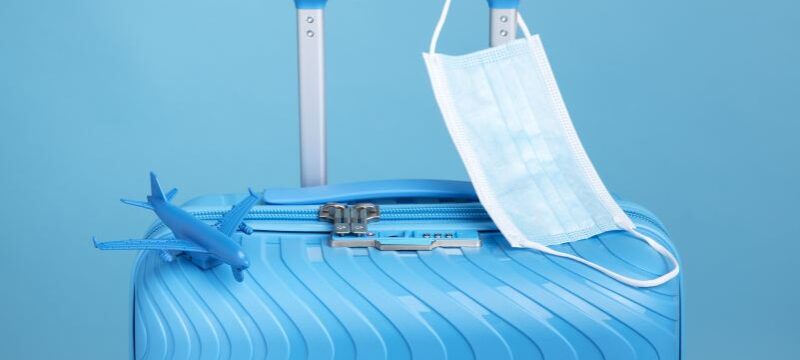 blue-suitcase-travel-with-medical-mask