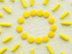 high-angle-view-yellow-candies-concrete-white-background