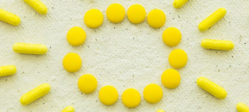 high-angle-view-yellow-candies-concrete-white-background