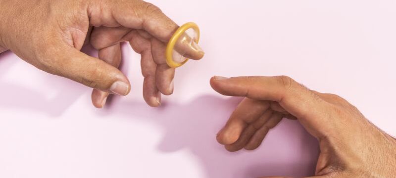close-up-man-hands-with-transparent-condom