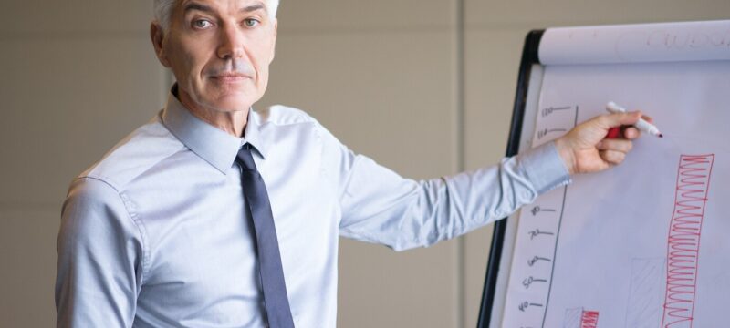 closeup-senior-expert-explaining-bar-chart_1262-1752