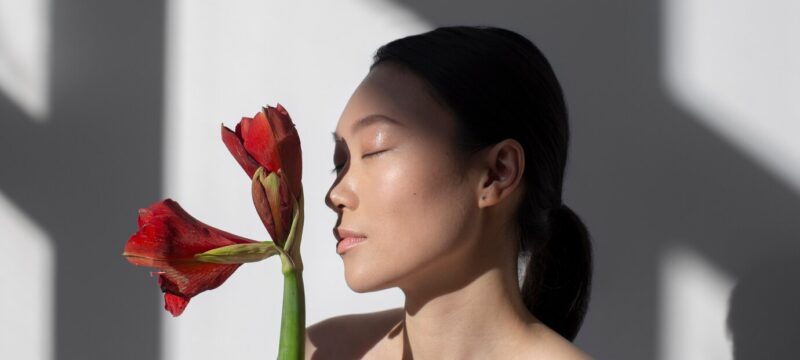 beautiful-asian-woman-posing-holding-rose-with-perfect-skin_23-2149369954