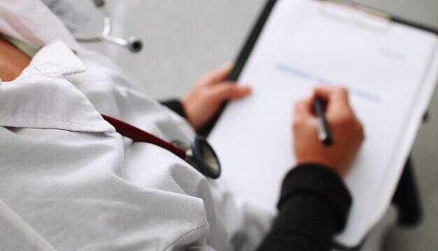 high-angle-view-doctor-writing-report-clipboard_1048944-14576366