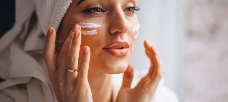 woman-applying-face-cream_1303-14312
