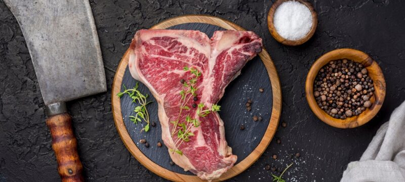 top-view-meat-with-spices-cleaver_23-2148610988