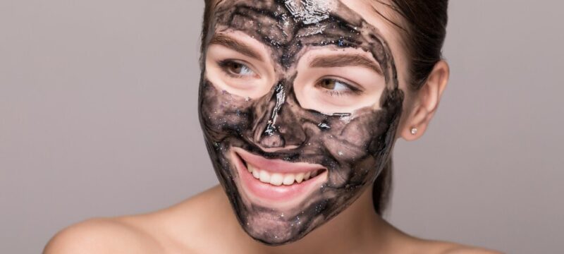 young-beautiful-woman-mask-face-therapeutic-black-mud-spa-treatment_231208-1553