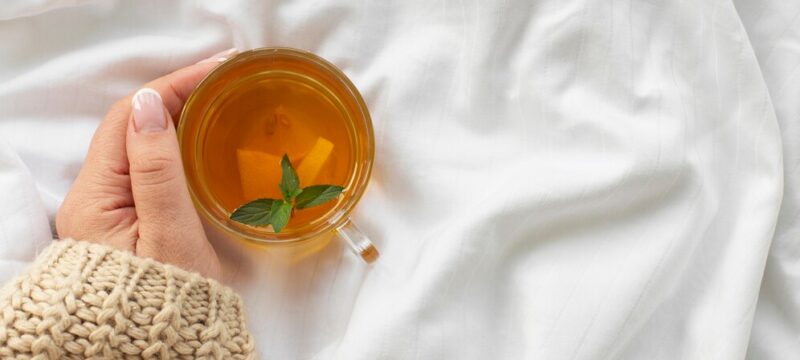 hand-holding-cup-tea-with-mint_23-2148349712
