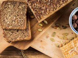 healthy-sunflower-seed-bread-hazelnut-bowl-with-protein-bar-chopping-board_23-2147906735