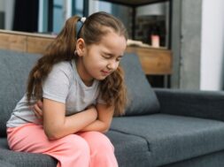 little-girl-holding-hands-her-stomach-suffering-from-pain_23-2148053195