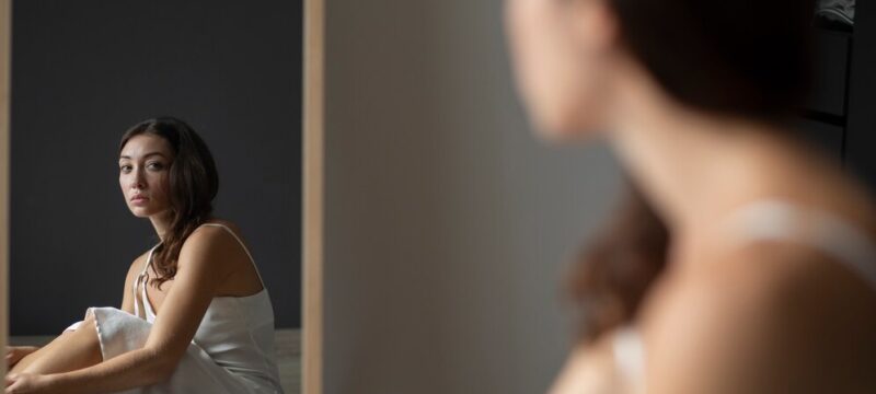 portrait-young-woman-with-low-self-esteem-with-mirror_23-2150038921