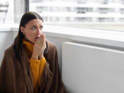 woman-covered-with-blanket-suffer-from-lack-heat-sitting-cold-living-room-near-radiator-no_726520-3670