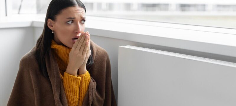 woman-covered-with-blanket-suffer-from-lack-heat-sitting-cold-living-room-near-radiator-no_726520-3670