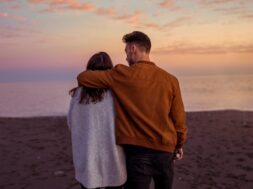 young-couple-hugging-sandy-sea-shore-evening_23-2148020127