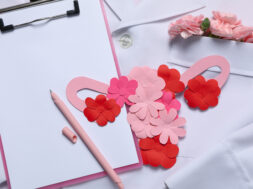 Doctors coat with flowers, clipboard, pen and uterus – Doctor Gy