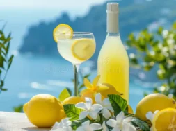 limoncello-liqueur-glass-bottle-ripe-yellow-lemons-background-beautiful-sea-coast-lemon-drink-315834836