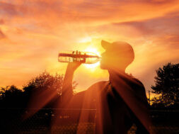 Silhouette of a man drinking water during heat wave
