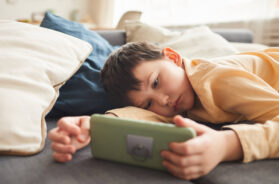Bored-Little-Boy-Using-Smartphone