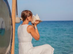 Woman blowing conch shell