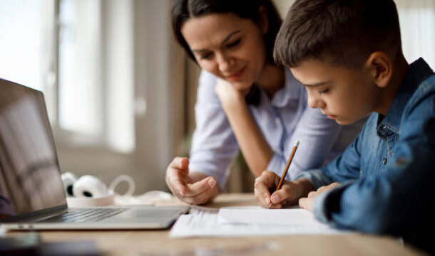 Mother helping teenager with homework